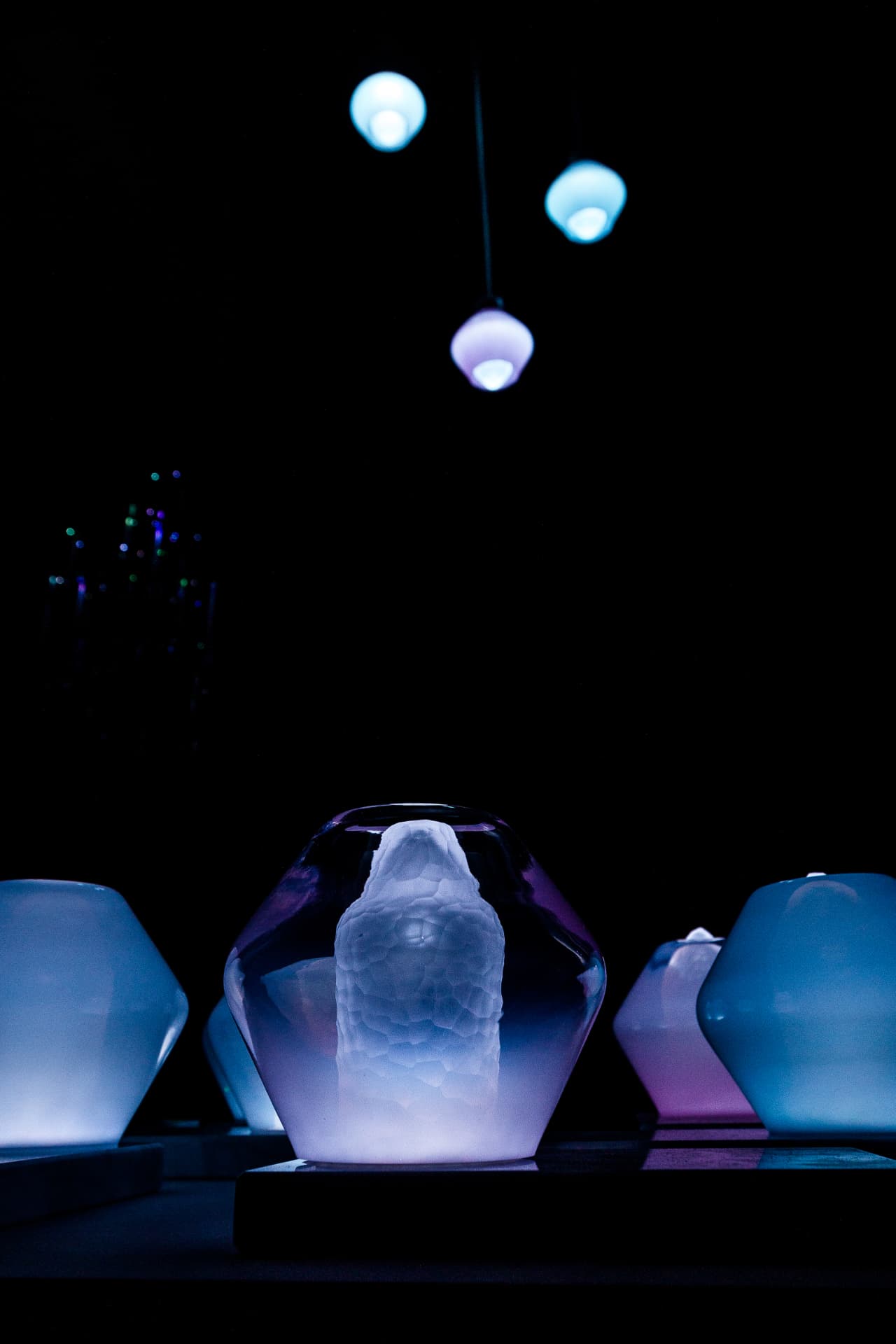 Jewel Lamps — table lamps in the foreground with the pendant lights glowing above