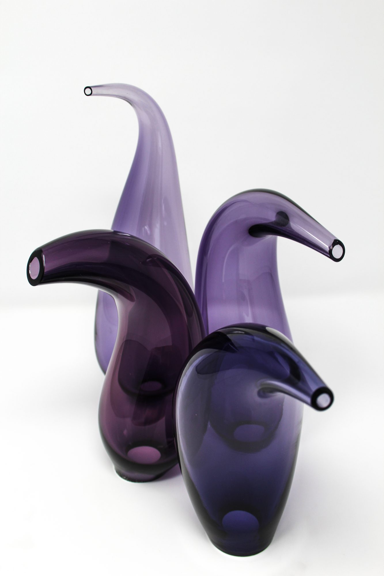 Fluidity — four curved blown glass forms viewed from above