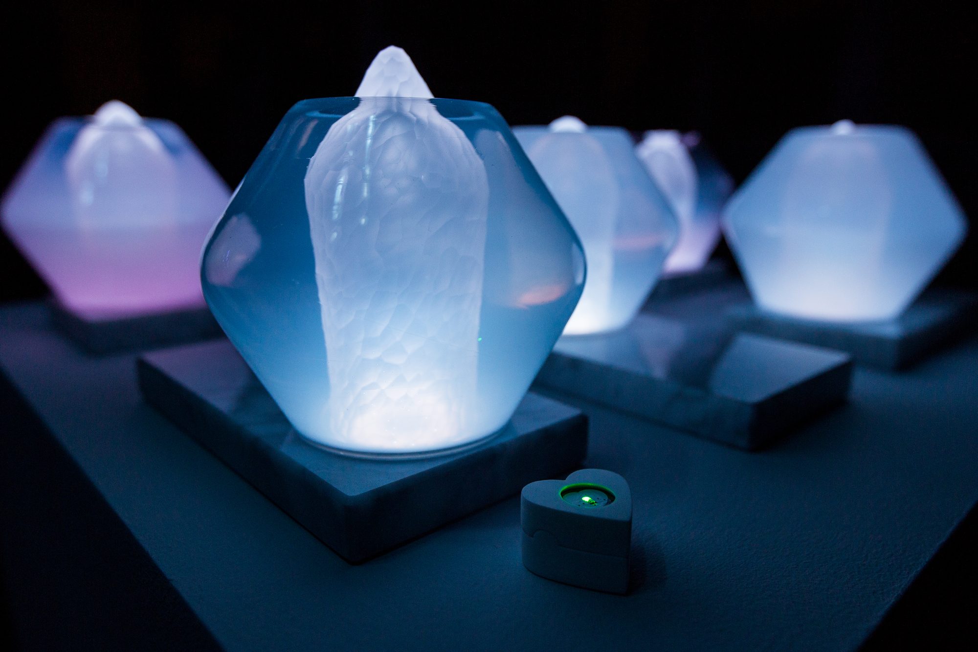 Jewel Lamps — group of illuminated glass lamps on marble bases