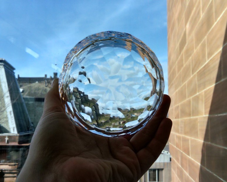 Further view through the cut crystal against buildings and sky