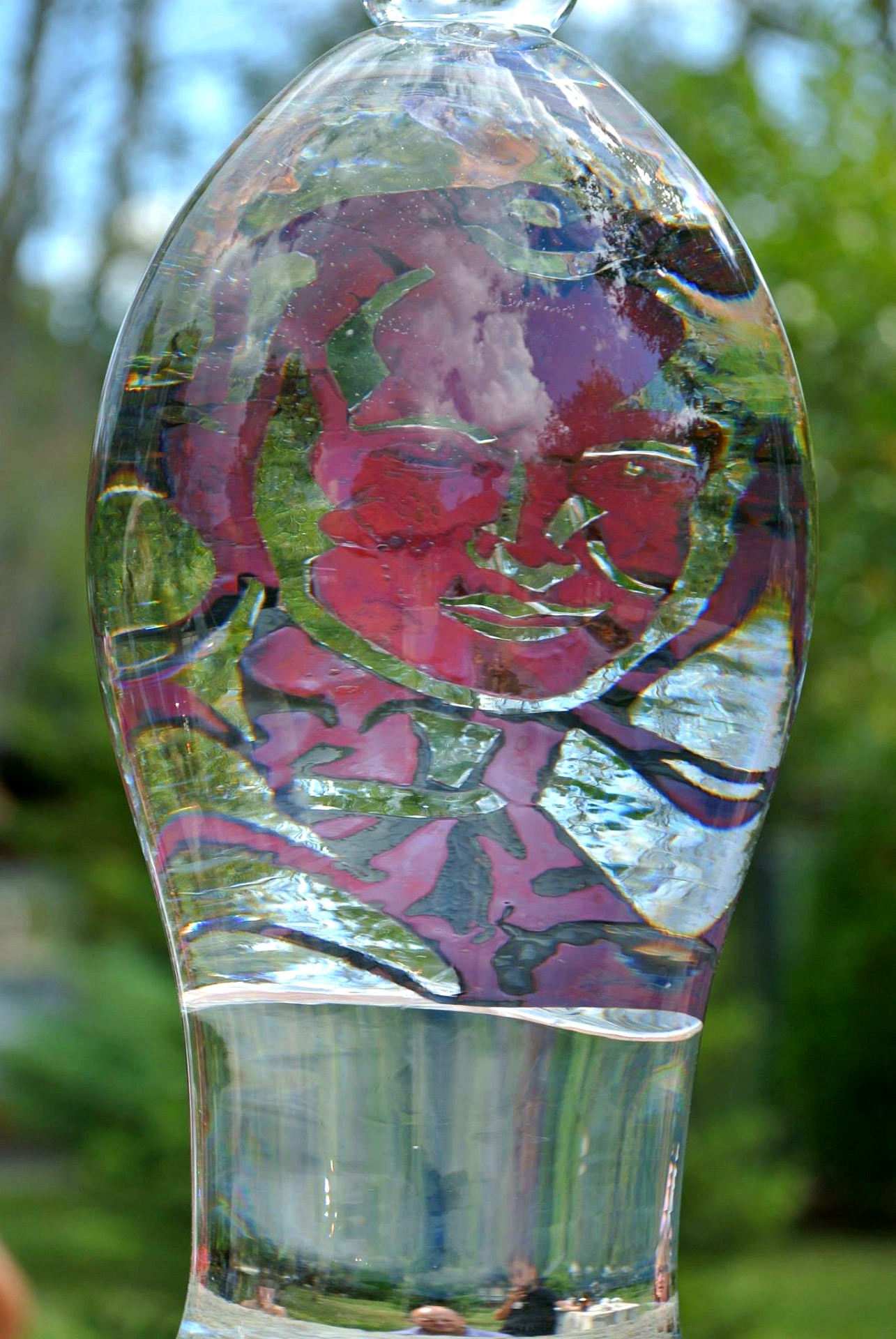 A pair of the glass forms seen against trees and sky